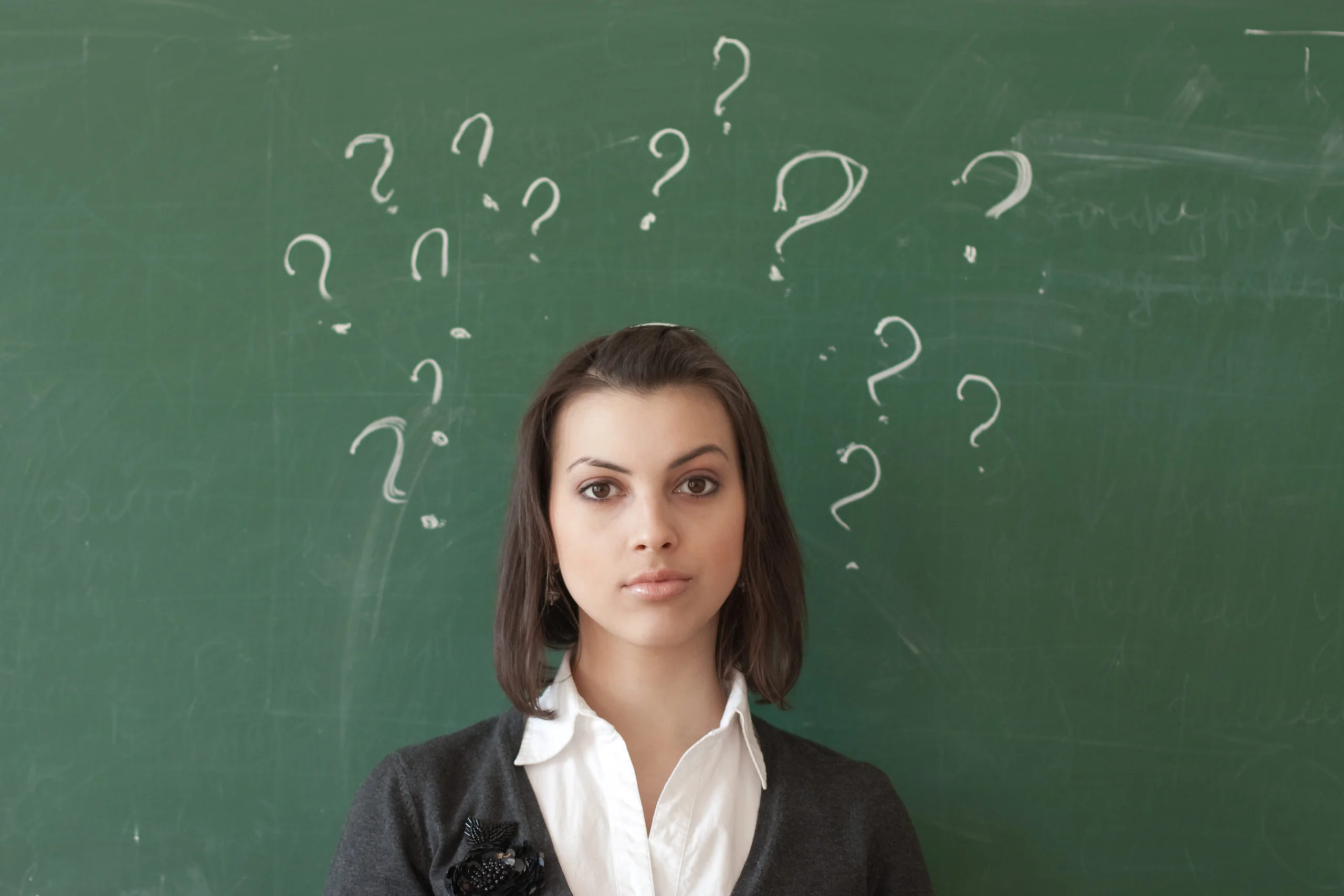 student-at-blackboard-with-question-marks-scribbled