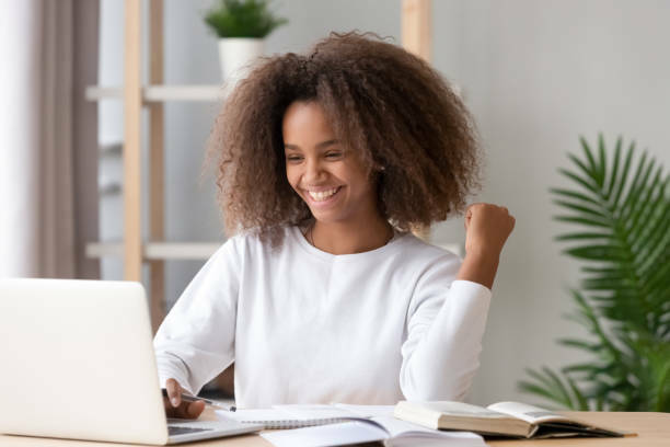 smiling-teenage-african-american-girl-on-laptop