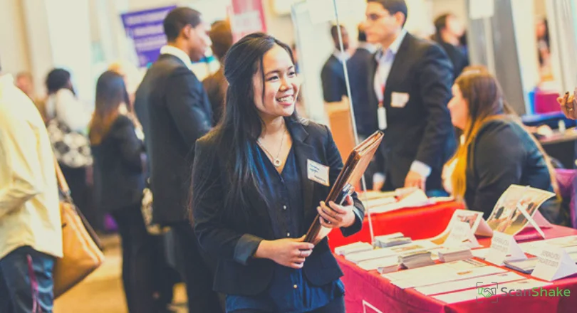 asian-female-college-recruiter-at-college-fair